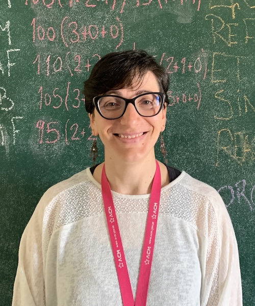 Sara Borges in front of a chalkboard