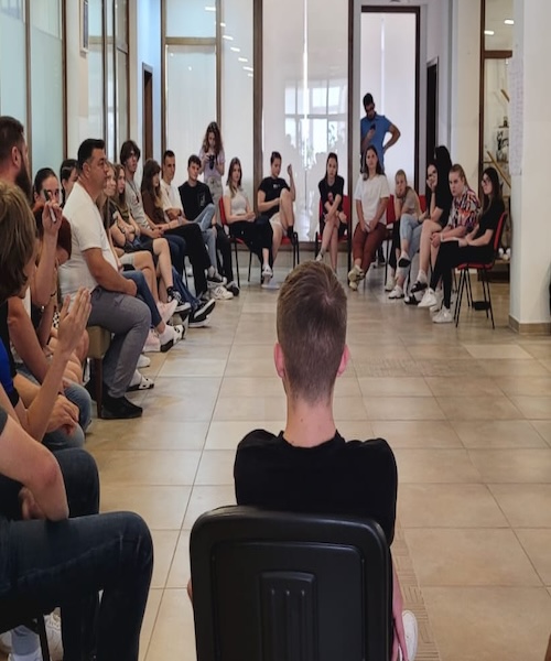 A circle of students and leaders engaging in a group activity