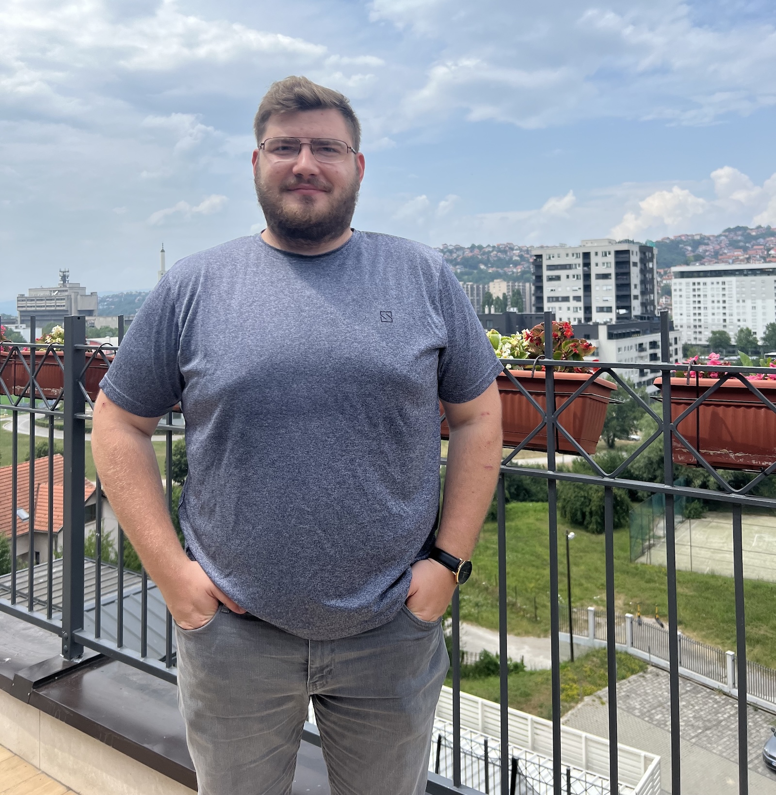 Stefan Kukric standing outside in a blue T-shirt and jeans