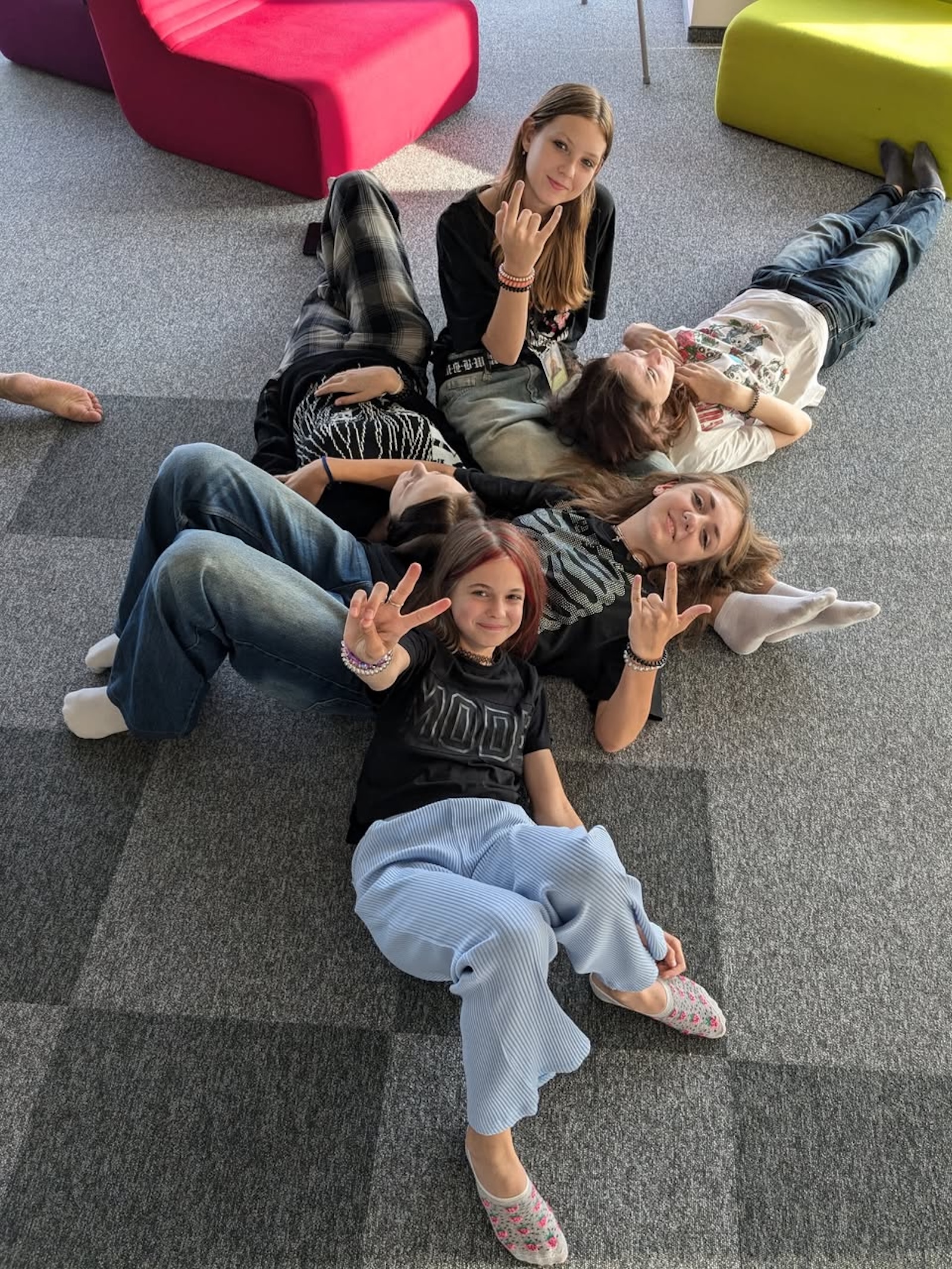 Students lounging and showing peace signs