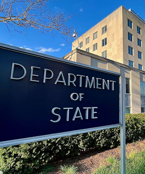 "Department of State" sign in front of a federal building