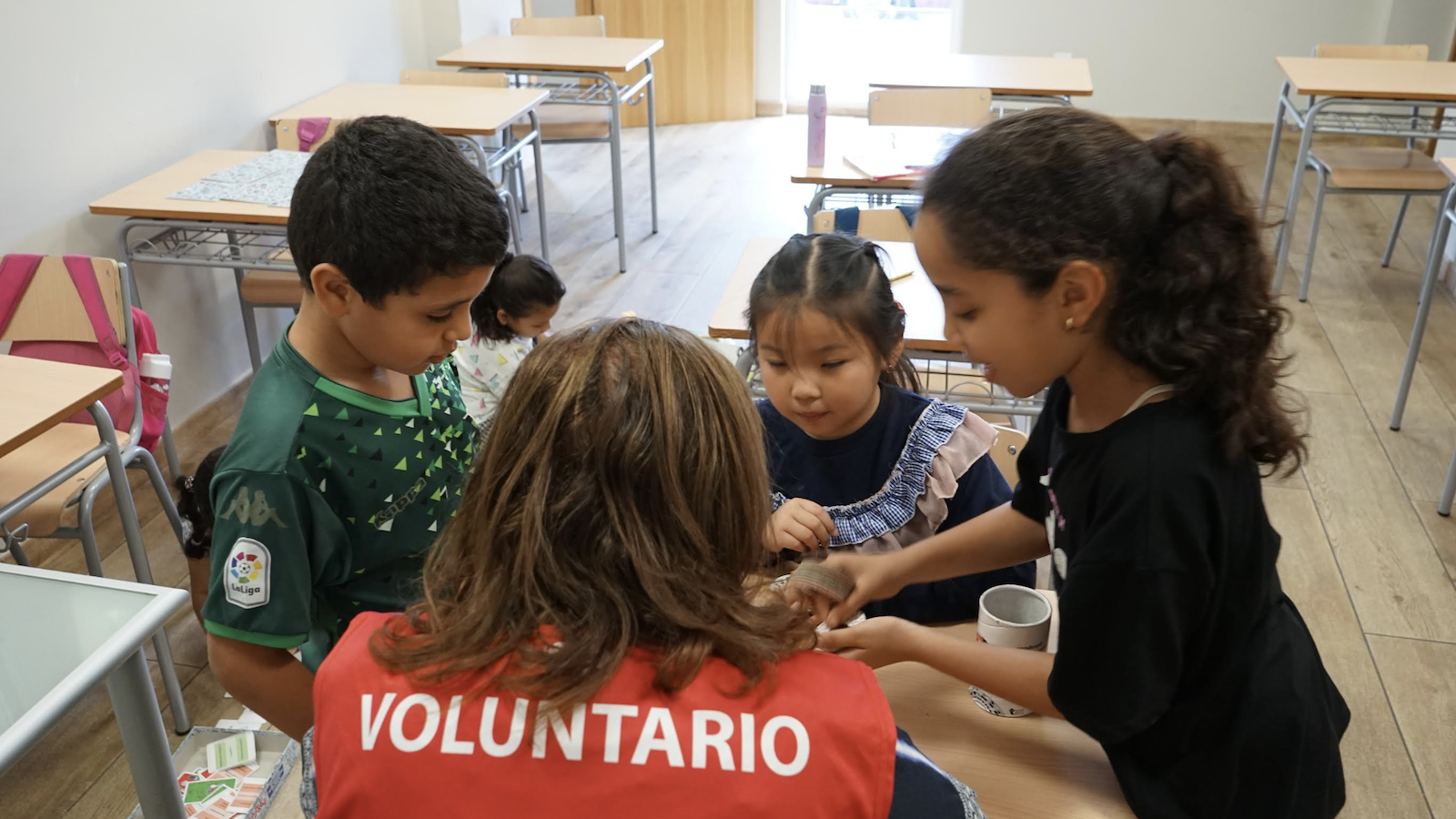 A volunteer helping children