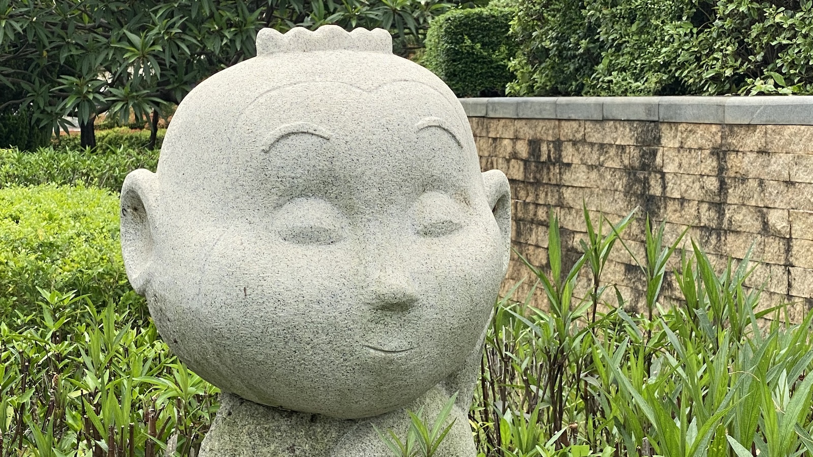 A granite statue of a monkey head in the Wenpushan Cemetary outside of Xiamen, China.
