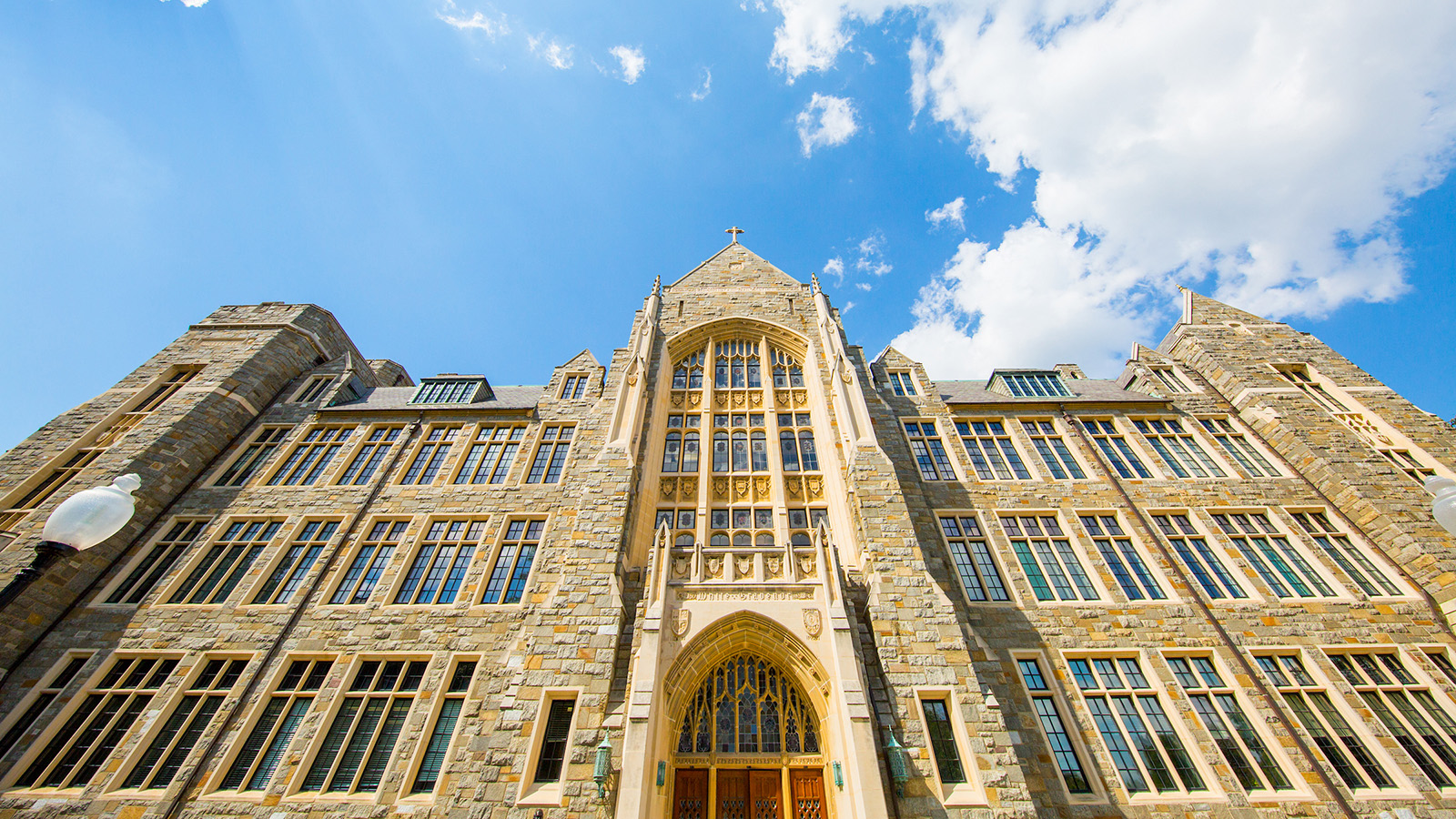 White-Gravenor Hall in forced perspective from the ground looking towards the blue sky with clouds