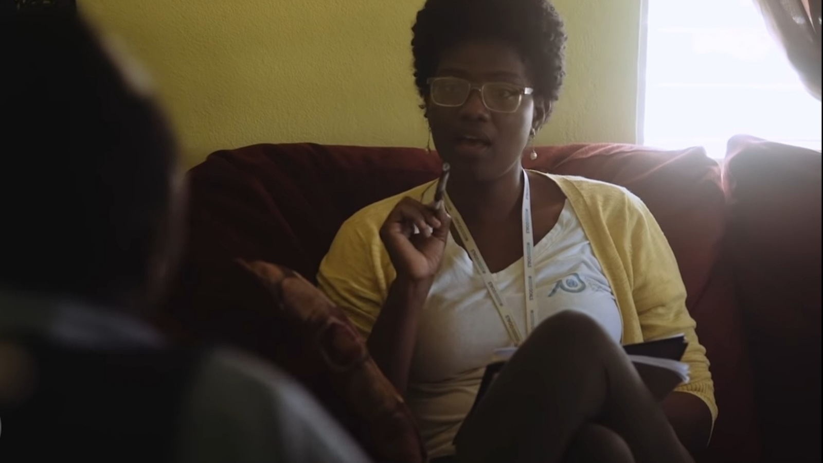 Woman in a yellow sweater talking