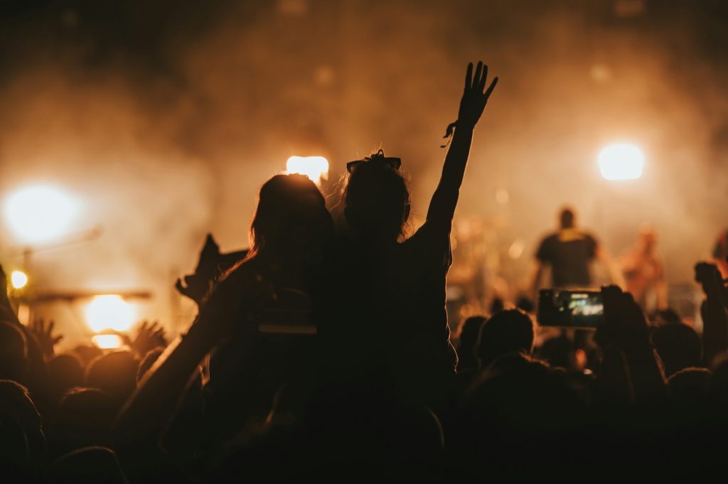 Two woman in the crowd at a music festival