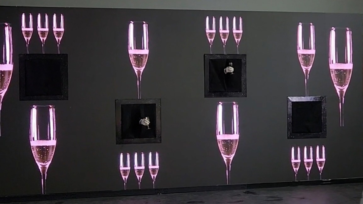 Video Wall Serving Hands