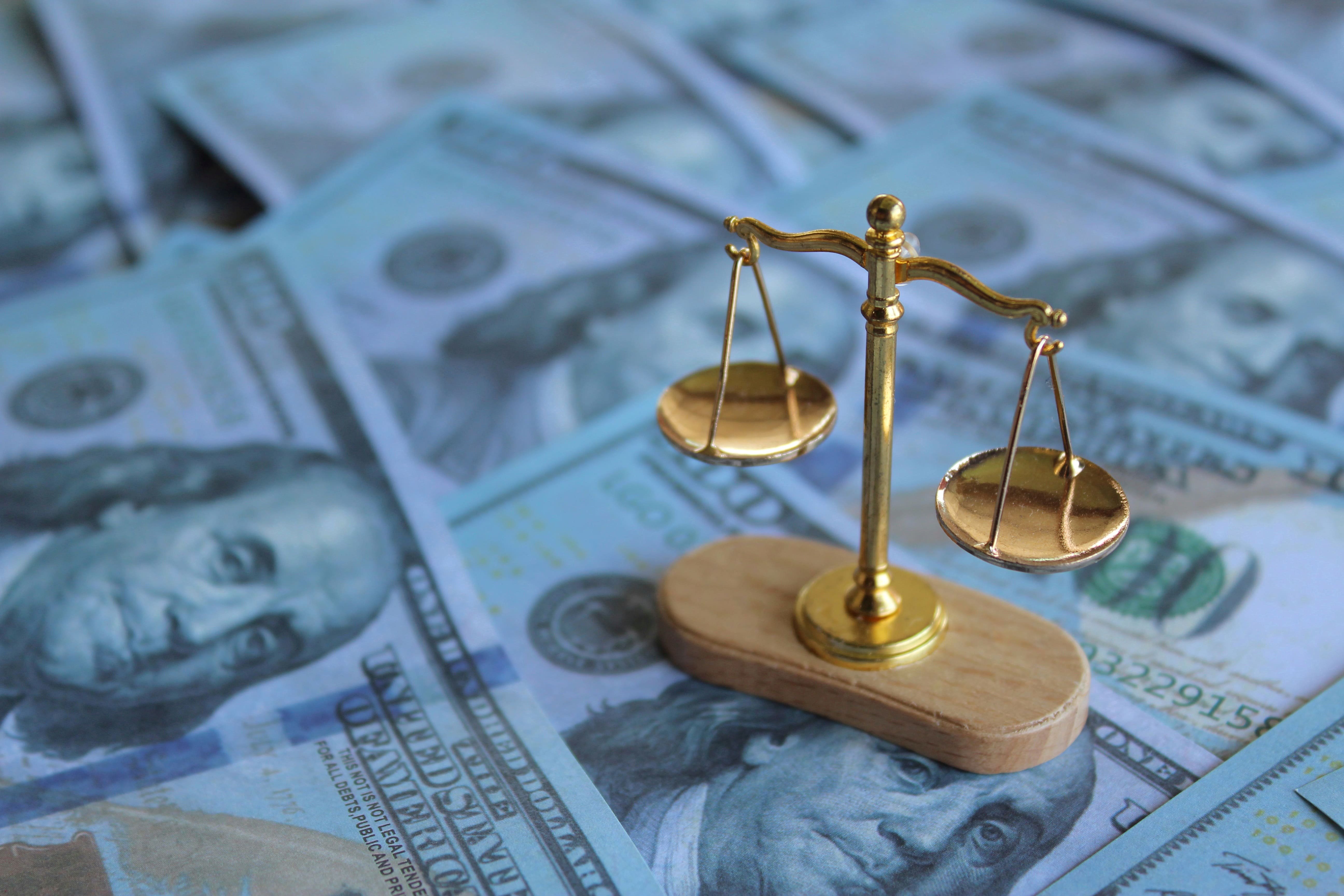 balancing-scale-on-top-of-money-2023-11-27-05-29-25-utc (1).jpeg
