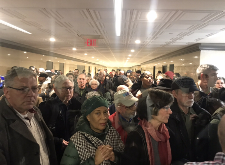 Crowd gathers outside of a the NYC Dept. of Planning hearing room ahead of the 960 Franklin Avenue Rezoning scoping meeting. Photo: Kadia Goba/Bklyner