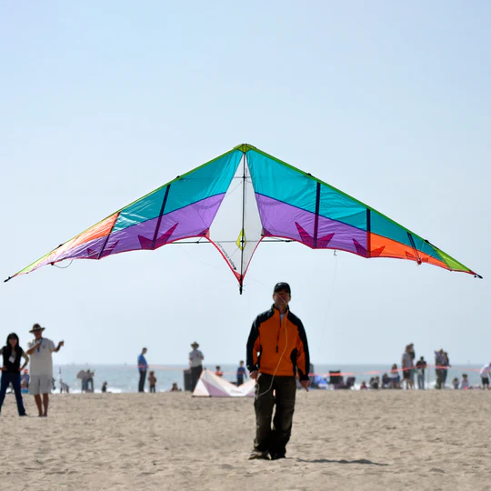 A man floats a professional good flying kites in the blue sky