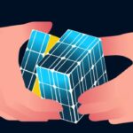 Two hands solving puzzle cube made of solar panels with pyraminx solution