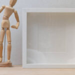Action Figure Display Boxes And Action Figures Are Placed On The Wooden Table For Display