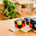 A Bunch Of Rubik's Cubes On The Table And I'm Practicing Speed Solving Them Using Beginner Pll Algorithms