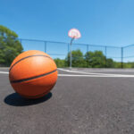 The Photo Shows Playground Balls On An Outdoor Basketball Court