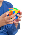 The Child Is Using Pll Algorithms To Quickly Solve A 3x3 Rubik's Cube