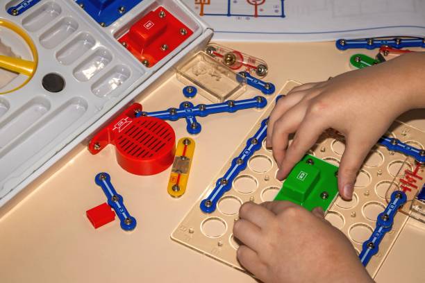 A child is assembling stem toys for 8-year-olds on a table
