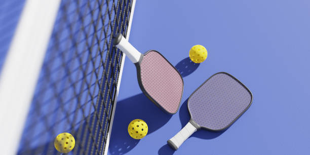 Rackets And Balls For Playing Pickleball At The Sports Net On The Court,also Fall Under The Category Of Sports Ball Sets
