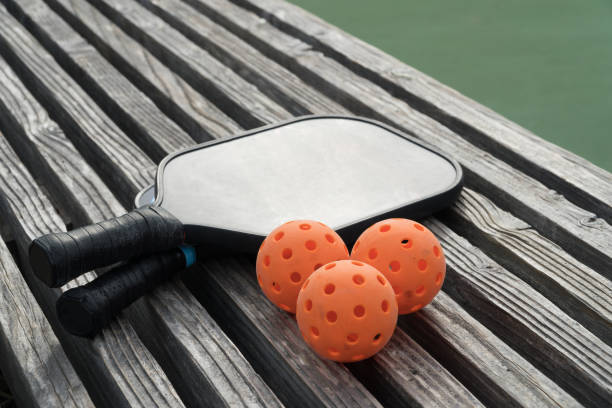 The Pickleballs And Rackets On The Bench Also Fall Under The Category Of Sports Ball Sets
