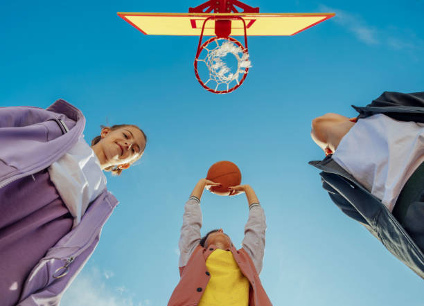 Teenagers Hone Their Basketball Skills Outdoors Using Basketball Gifts For 10 Year Old Boy