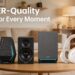 Promotional image with text overlay reading "EDIFIER-Quality Audio for Every Moment". It showcases the gaming satellite speaker, studio desktop speaker, subwoofer, and wireless ANC headphones lined up on a living room coffee table.