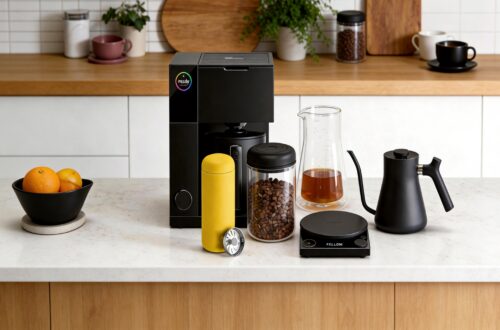 Complete Fellow coffee brewing setup featuring Aiden coffee maker, Carter Move mug, Atmos canister, Stagg kettle, Tally Pro scale, and double-wall coffee carafe arranged on a bright kitchen island.