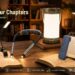 Glocusent brand banner titled "Light Up Your Chapters" featuring a collection of neck lights, clip-on lamps, and camping lanterns on a cozy wooden table