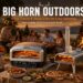 Big Horn Outdoors brand banner showcasing their complete outdoor lineup of stainless-steel pizza ovens and infrared steak grills during a festive twilight lakeside RV camping party.