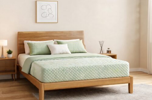 A minimalist Japanese-style wooden bedroom featuring an EGOHOME mattress with a light green quilted diamond pattern cover, decorated with matching green and white pillows for a natural, soothing atmosphere.