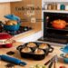 An extensive view of a kitchen counter showcasing numerous colorful enameled cast iron pots and fresh produce. It includes the dark blue bread cloche, the red double loaf pan, the black mini bread pan, and the light blue long loaf pan. The text "Endless Meals in Style" and logos are visible.