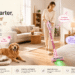 Trucozie home-cleaning lineup shown in a warm modern interior, featuring a pink cordless vacuum, large pet air purifier, and mattress vacuum cleaner. A woman cleans the floor while a dog and cat relax nearby, highlighting smart cleaning for floors, beds, and pet homes.