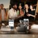 ELEHEAR brand showcase featuring multiple hearing aid models, charging cases, smartphone apps, cleaning accessories, and real-life usage scenes. The banner highlights rechargeable technology, app control, comfort fit, daily care, and meaningful listening moments.