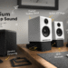 A complete product lineup infographic for Audioengine premium desktop sound system, featuring A2+ speakers on stands, an S6 subwoofer, and a B1 receiver on a desk with annotations for deep bass, vibration dampening, premium sound, 15-degree angle, and wireless and Hi-Fi bluetooth.