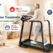 A 16:9 hero image for the Redliro senior treadmill blog, showing an older man walking on a black Redliro treadmill in a bright, cozy living room. The left side features brand messaging and text such as “Start Slower” and “Shop Now,” surrounded by red and navy cartoon-style callouts highlighting the ultra-low start speed, extended safety handrails, reverse-walking posture support, and space-saving foldable design.