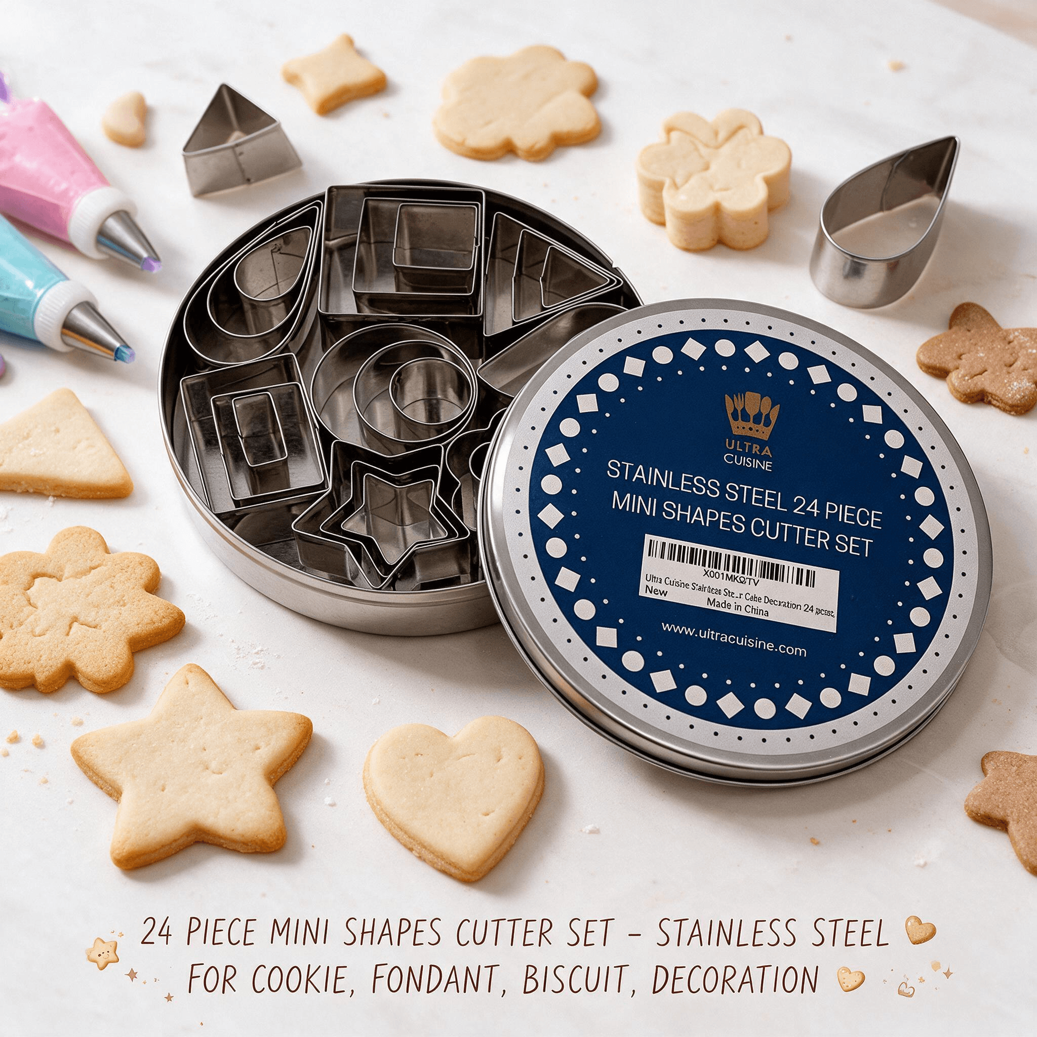 An open round tin revealing an Ultra Cuisine 24-piece stainless steel mini shapes cutter set, surrounded by freshly baked shaped cookies. Text mentions it is ideal for cookies, fondant, biscuits, and decoration.