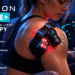 KINEON MOVE+ wearable red light therapy device on a woman's shoulder, featuring glowing red LEDs, adjustable straps, and a knee therapy inset. A modern fitness setting with blue lighting highlights portable muscle and joint recovery support.