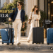LEVEL8 premium luggage collection featuring blue expandable carry-on, sleek black suitcase, and matching luggage sets outside a luxury hotel, highlighting 360° spinner wheels, modern design, and smart travel essentials.