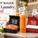 Laundry Sauce luxury laundry collection featuring detergent pods, French Saffron dryer sheets, Italian Bergamot fabric softener, and fabric refresher spray in an elegant laundry room.