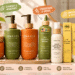 A 16:9 promotional banner featuring Lebanta hair care products arranged in a bright, realistic bathroom vanity setting, with clear English text annotations and playful cartoon graphic markers highlighting natural hair care benefits.