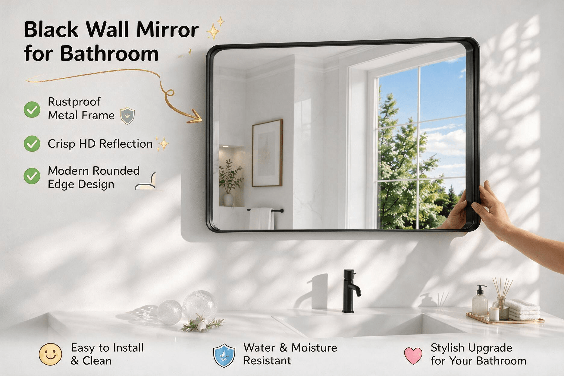 Black metal rounded-corner framed wall-mounted bathroom mirror hanging above a bright modern white vanity, reflecting green trees through the window, annotated with rustproof metal frame feature