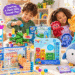 Hand2mind educational toys displayed in a colorful playroom, featuring Numberblocks math sets, sensory tubes, emotion puppets, and a plush penguin. Two children explore hands-on learning activities with playful English annotations.