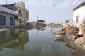 Six months after heavy rains in Pikine, Senegal, a few of the roads are still flooded. Photo by Jeff Deutsch/Oxfam America.