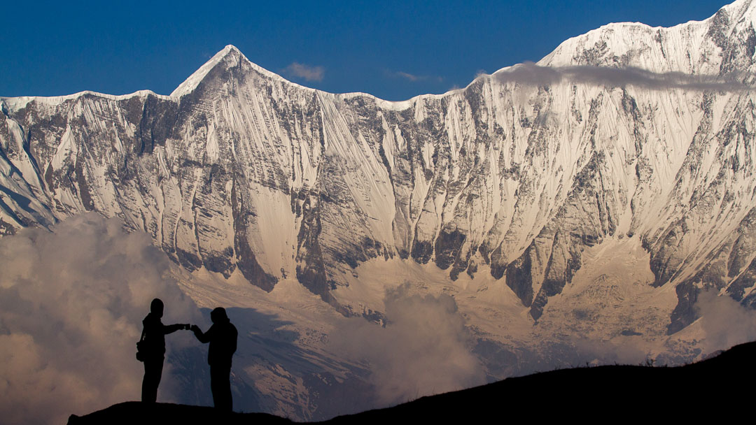Two trekkers celebrate awesome views during the Annapurna Seven Passes Trek