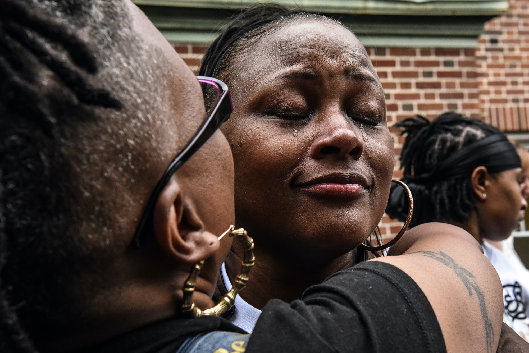 Blondina Bean is comforted while she cries at a memorial for her son, George Phillips, who was a victim of gun homicide in Baltimore, MD, U.S.