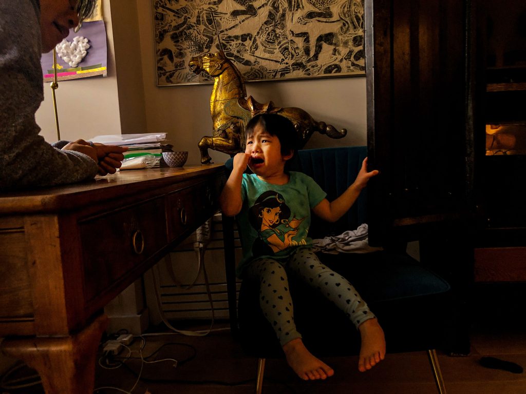 Xintian is crying by the desk at home, her mother is
