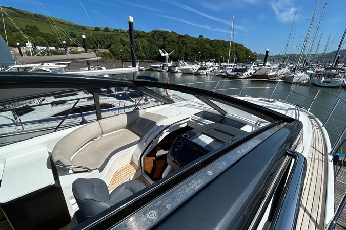2017 Princess V48 Open yacht docked at marina under clear blue sky.
