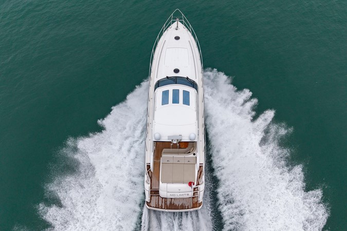 2009 Princess V58 yacht cruising on calm waters, side view.