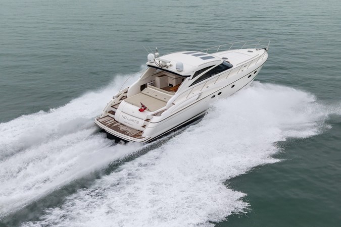 2009 Princess V58 yacht cruising on calm waters, side view.