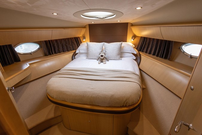 2009 Princess V58 yacht cruising on calm waters, side view.
