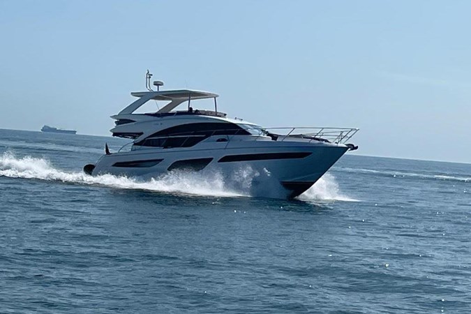 Luxury 2020 Princess F55 yacht docked in marina under blue sky.