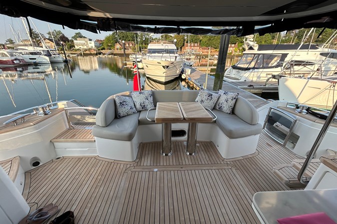 Luxury 2020 Princess F55 yacht docked in marina under blue sky.